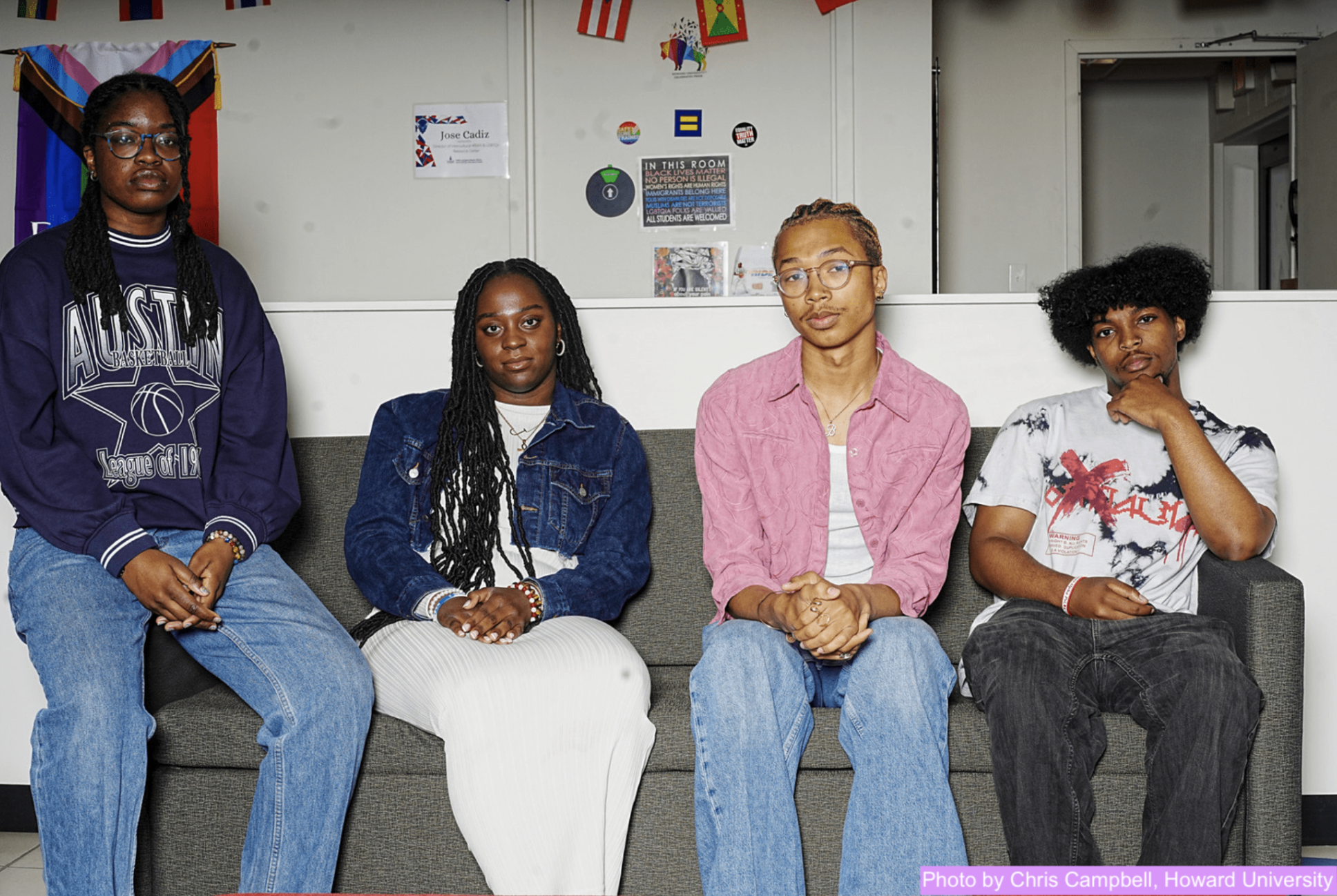 Four Black students sitting on a couch at Howard University. They are all facing the camera.